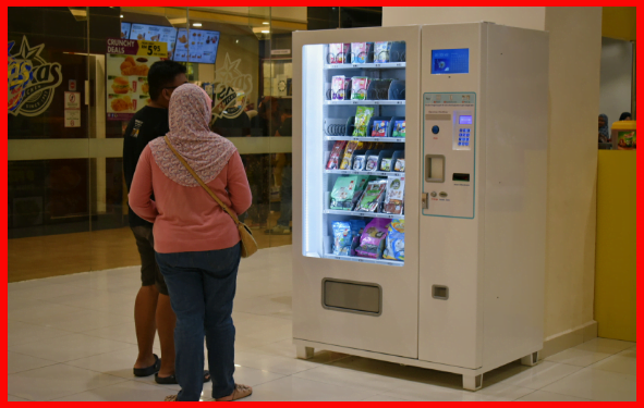 Clients Looking At The Vending Machine